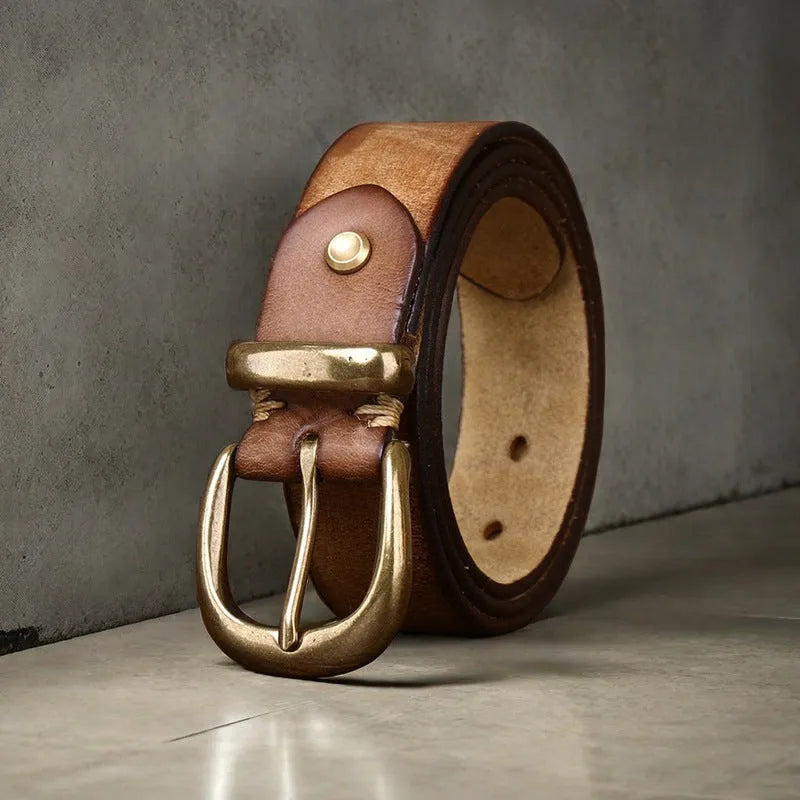 Men's brown genuine cowhide leather belt with a copper pin buckle on a jeans background.