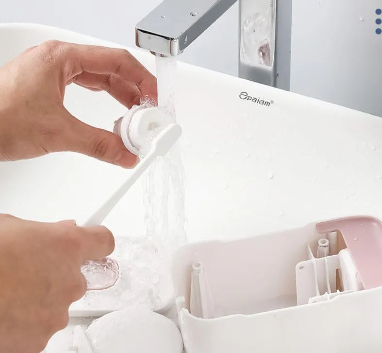 Blue automatic toothpaste dispenser mounted on bathroom wall with one-touch dispensing mechanism