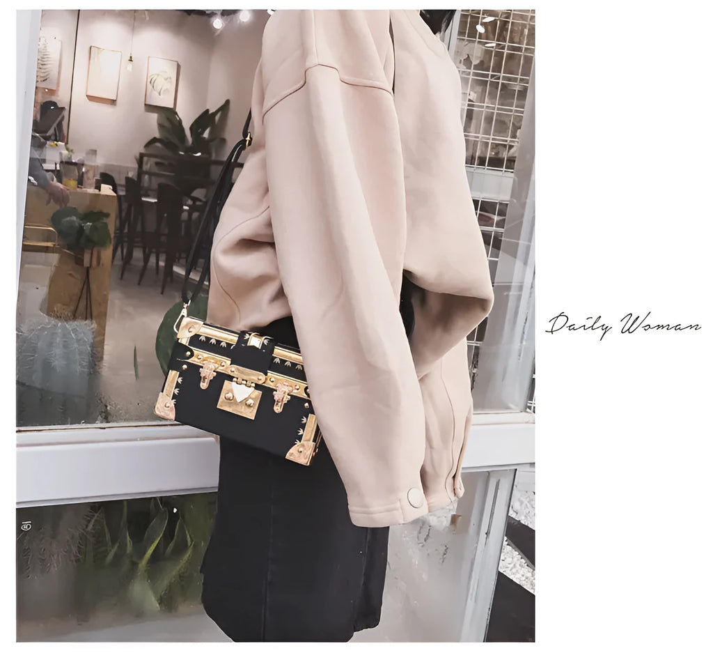 Women's hard frame shoulder bag in black or green with single adjustable strap and flap closure