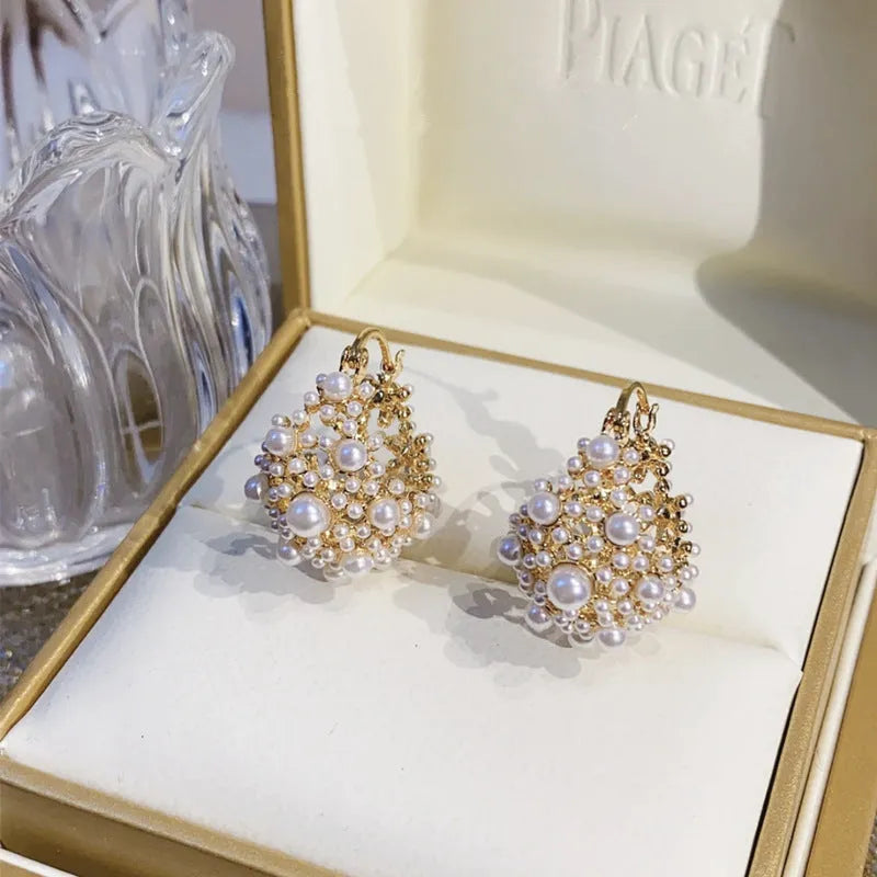 Women's gold flower basket earrings with small beads and pearl inlay details
