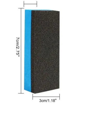 Blue labelled rust remover spray bottle next to a blue square sponge and a white towel on a grey background.