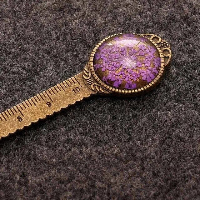 Handmade dried flower bookmark with ruler showing lace flowers, daffodils, and clover at 12cm length