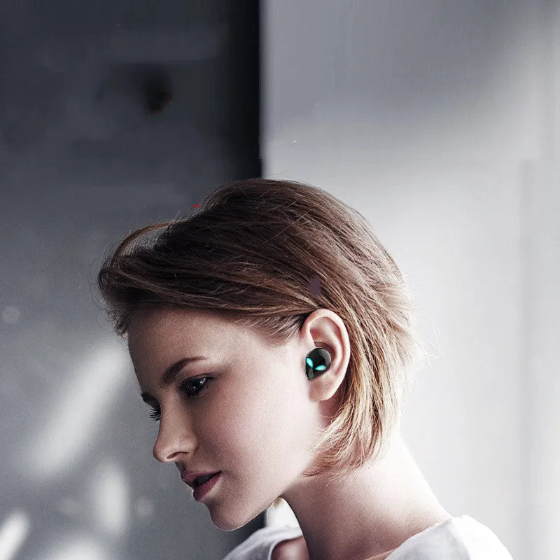 Creative Outer T8 Starman alien-design Bluetooth earbuds with red LED lights and wireless charging case.
