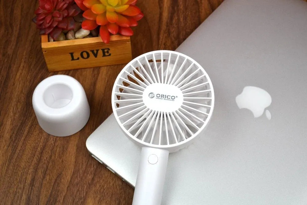 White ORICO FH1 USB rechargeable portable handheld and desktop fan with fine-line detailing.