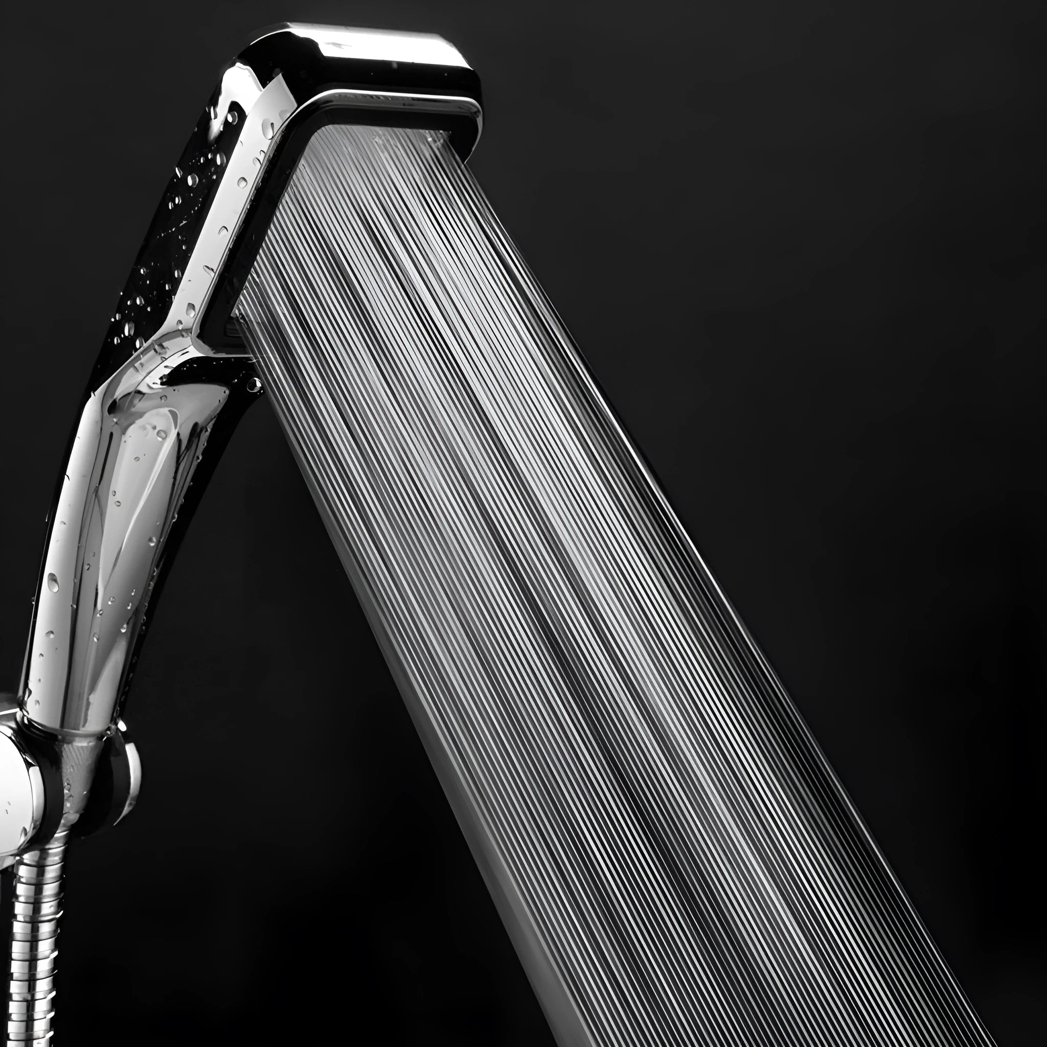 Orange hand-held pressurised shower with hose, set on a bathroom tile background.