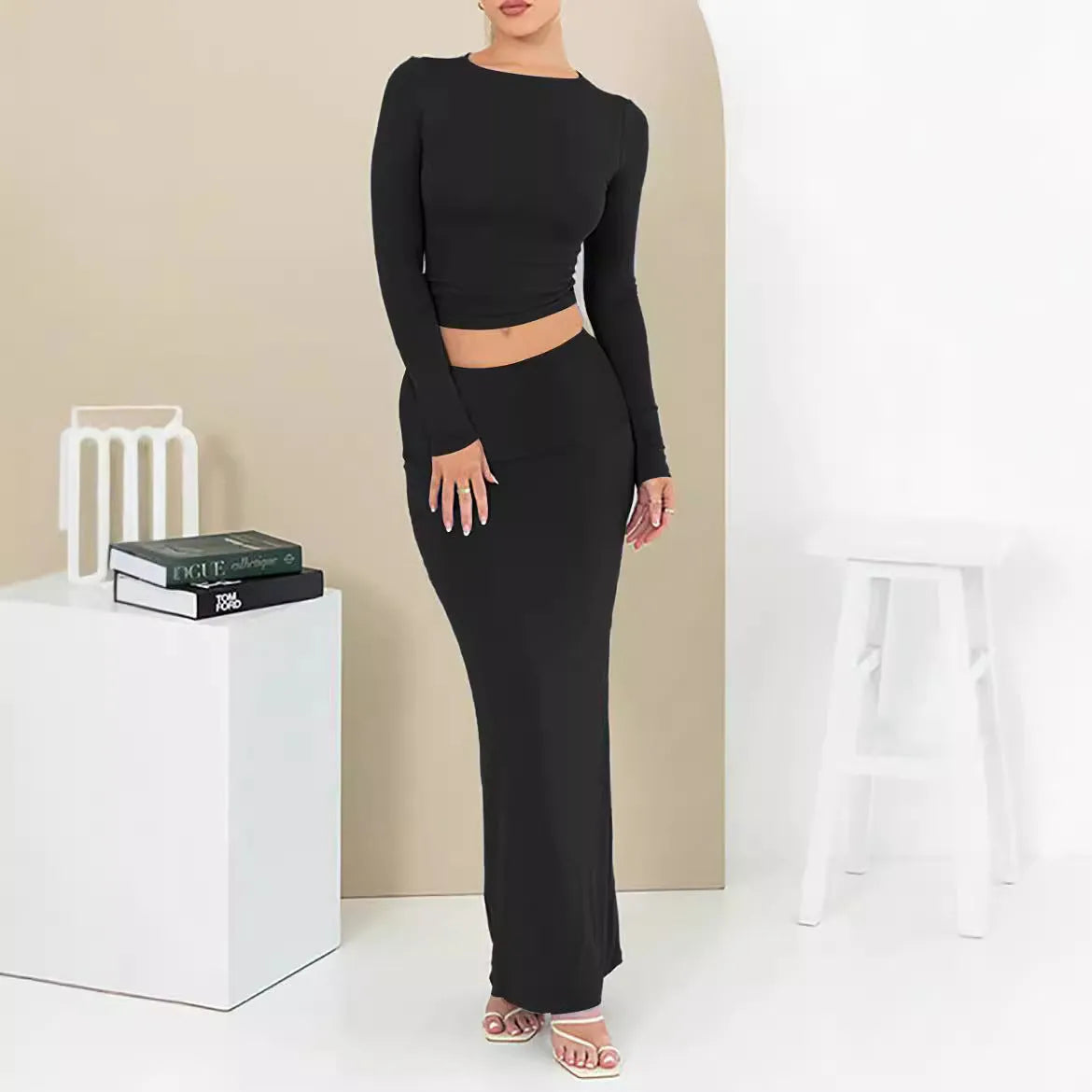 Women's sweet style two-piece suit with a cropped top and long skirt in polyester fabric.