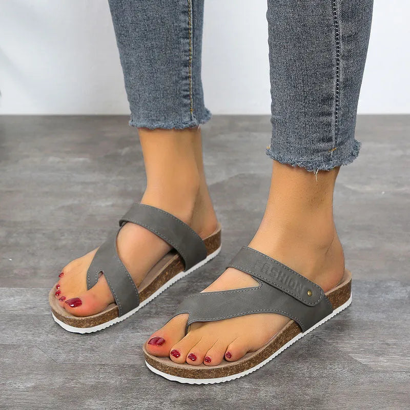 Blue thick-soled flat flip-flops with a toe ring on a foam sole.