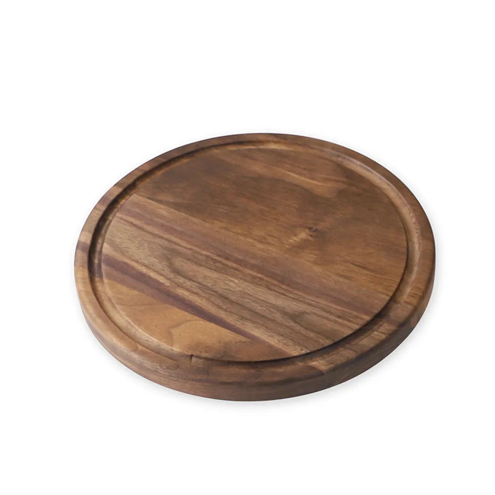 Solid black walnut wood cutting board with juice groove and side handle, shown in round and rectangular sizes.
