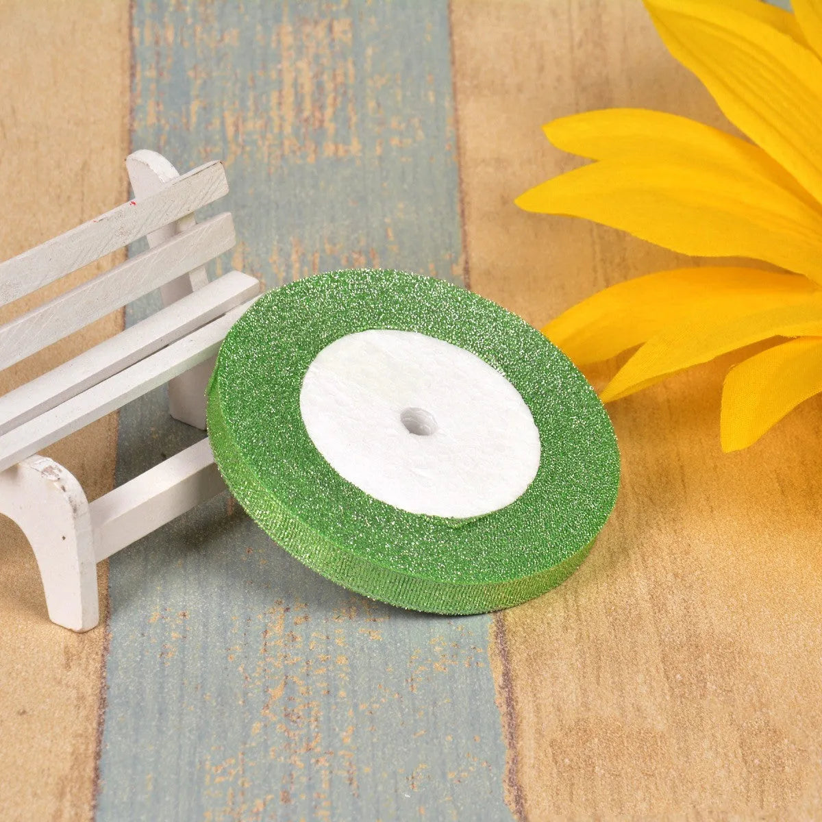 Green onion coloured polyester ribbon with gold polka dots on 25-yard spool for decorative trimming