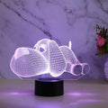 Doggo Desktop Lamp showing 3D dog illusion glowing in blue light on a desk