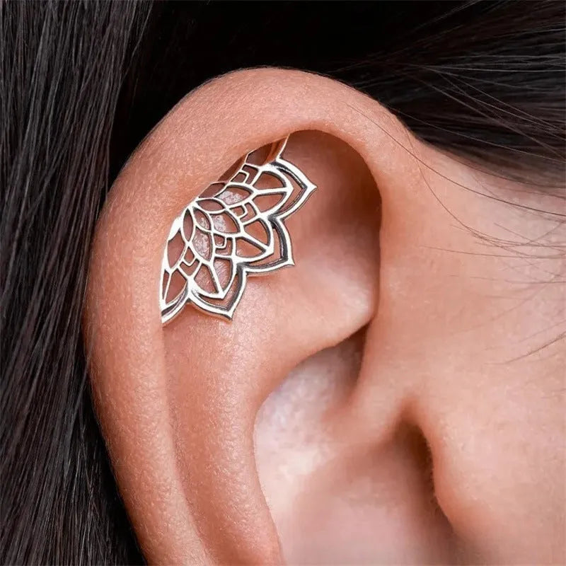 Geometric spider web design metal stud earrings in a gold electroplated finish.