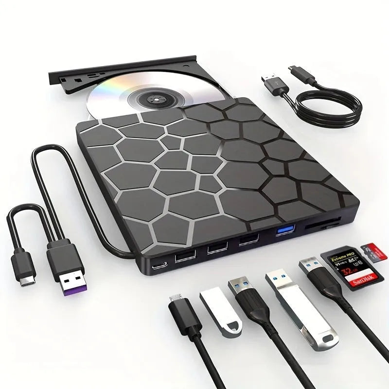 Black external USB CD DVD writer drive on a desk next to a laptop