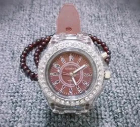 Women's LED luminous watch with round alloy case and colourful silicone strap.