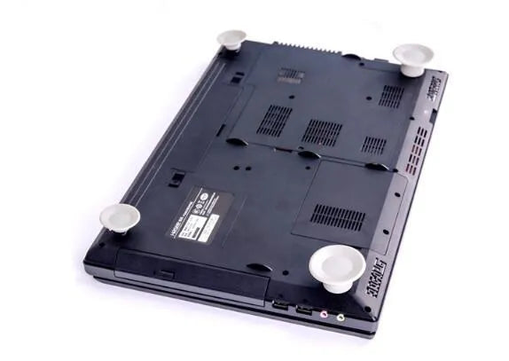 Set of four grey plastic laptop cooling pads, two large and two small, on a flat surface.