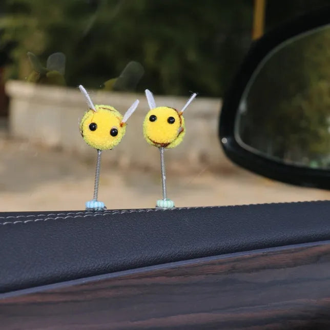Soft fur bee car decoration on a swing spring for dashboard personalisation.