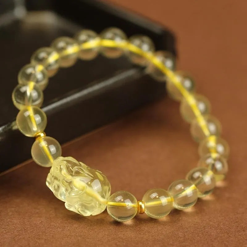Yellow leather bracelet with artificial crystal Pi Xiu bead in simple Chinese style.