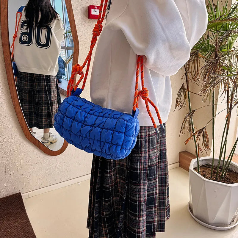 Soft nylon women's crossbody messenger bag in pillow shape with a rhombus pattern and a zippered inner pocket.