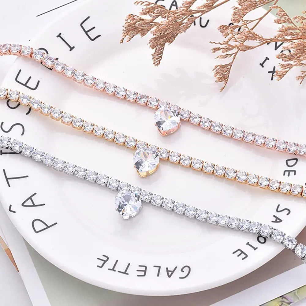 Gold rhinestone heart-shaped dog collar on a white background showing the shiny bling design.