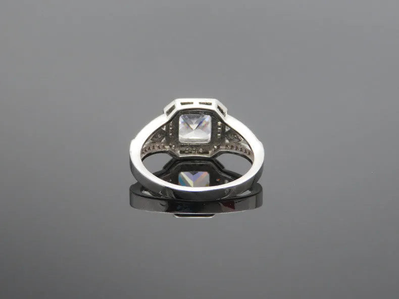 Women's geometric hollow zircon ring in platinum colour showing quadrilateral design and inlaid stones