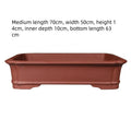 Large rectangular purple clay bonsai pot showing handmade texture and substantial size