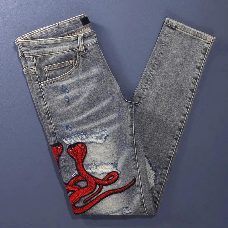 Slim fit jeans in washed-out old colour with patch embroidery detail on the leg.