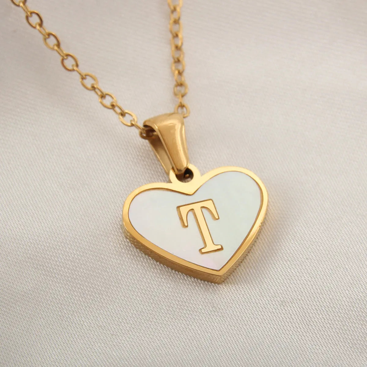Gold plated heart necklace with white shell detail on an adjustable chain