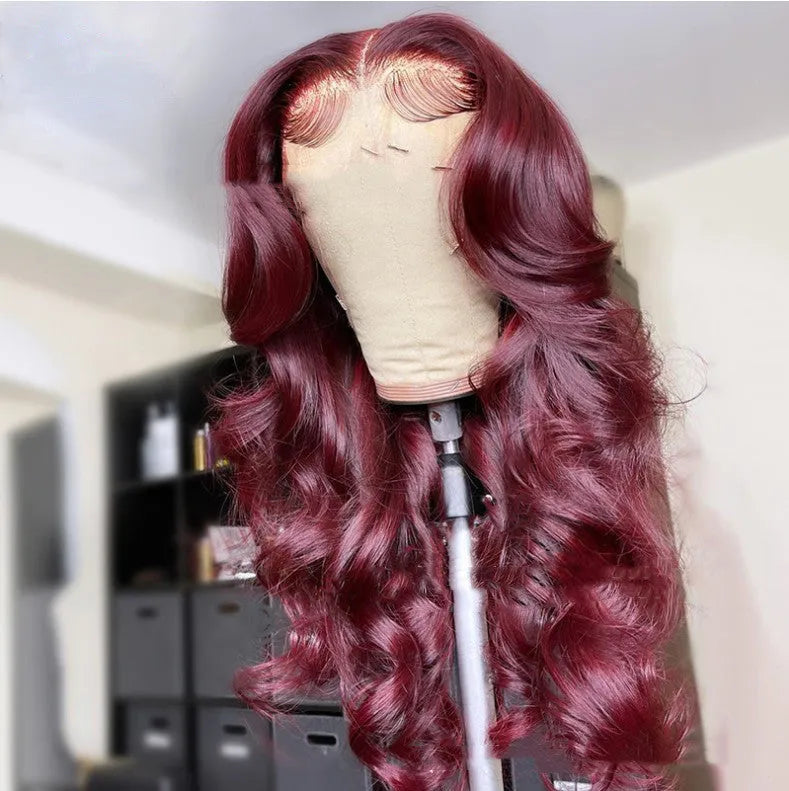Front lace synthetic wig in wine red long curly style with long bangs on a mannequin head