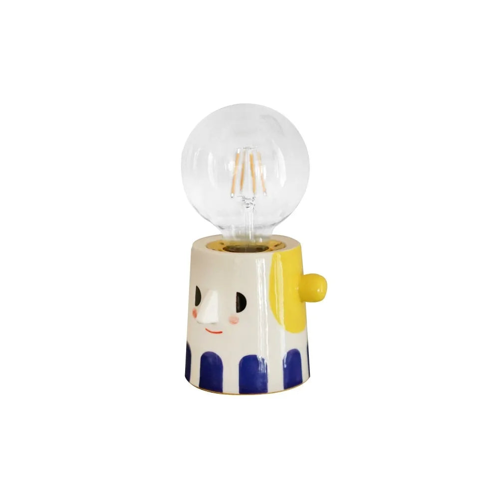 Handmade ceramic lamp with ball headlight design on bedside table