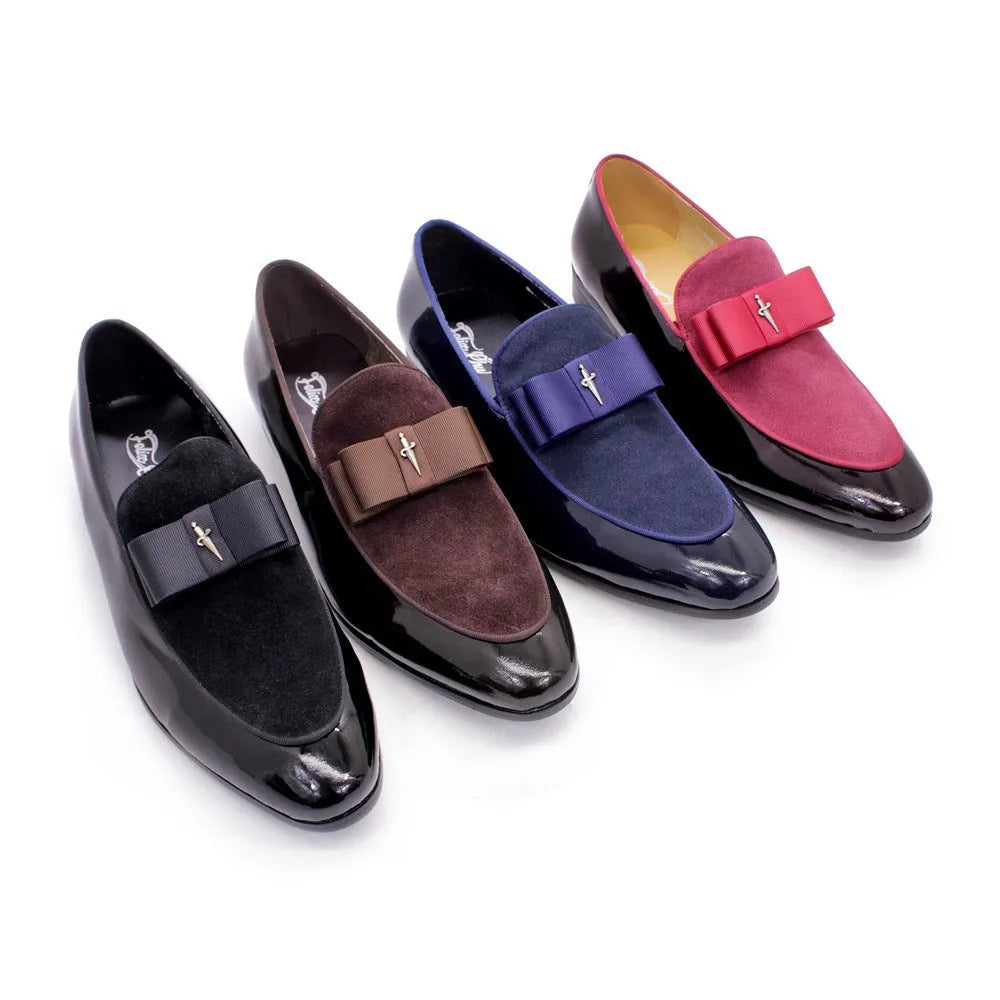 Men's black patent leather low-top shoes with a gold tassel detail on a white background.