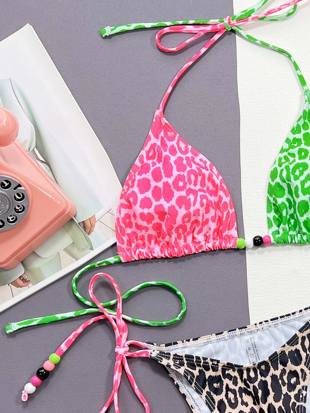 Women's leopard print bikini swimsuit with bra and briefs on a mannequin.