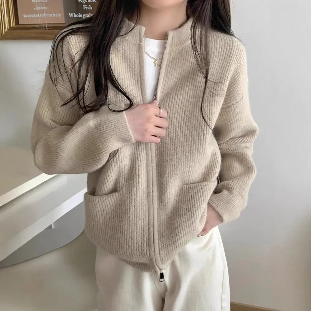 Beige viscose fibre long sleeve cardigan sweater coat laid flat, showing button front and soft texture.