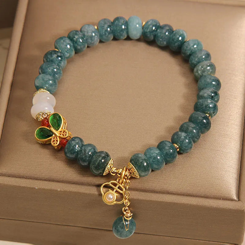 Blue water jade bracelet with white agate abacus beads and butterfly charm