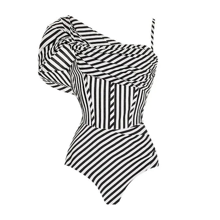 Women's striped one-piece swimsuit with a black ruffle skirt, shown on a mannequin.