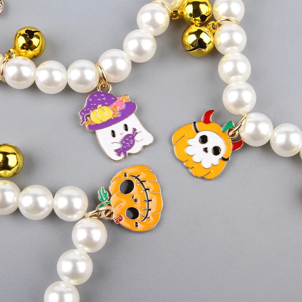 Halloween cat collar decoration with simulated pearls in purple ghost, skull, and smiling pumpkin designs.