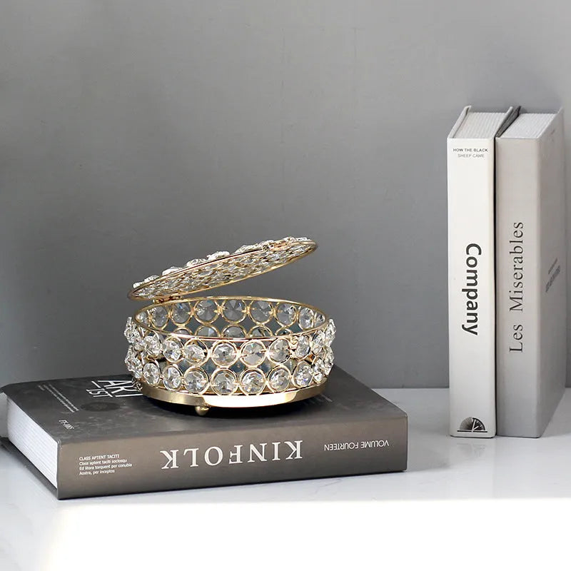 French gold metal jewelry box with a clear crystal glass front panel on display.