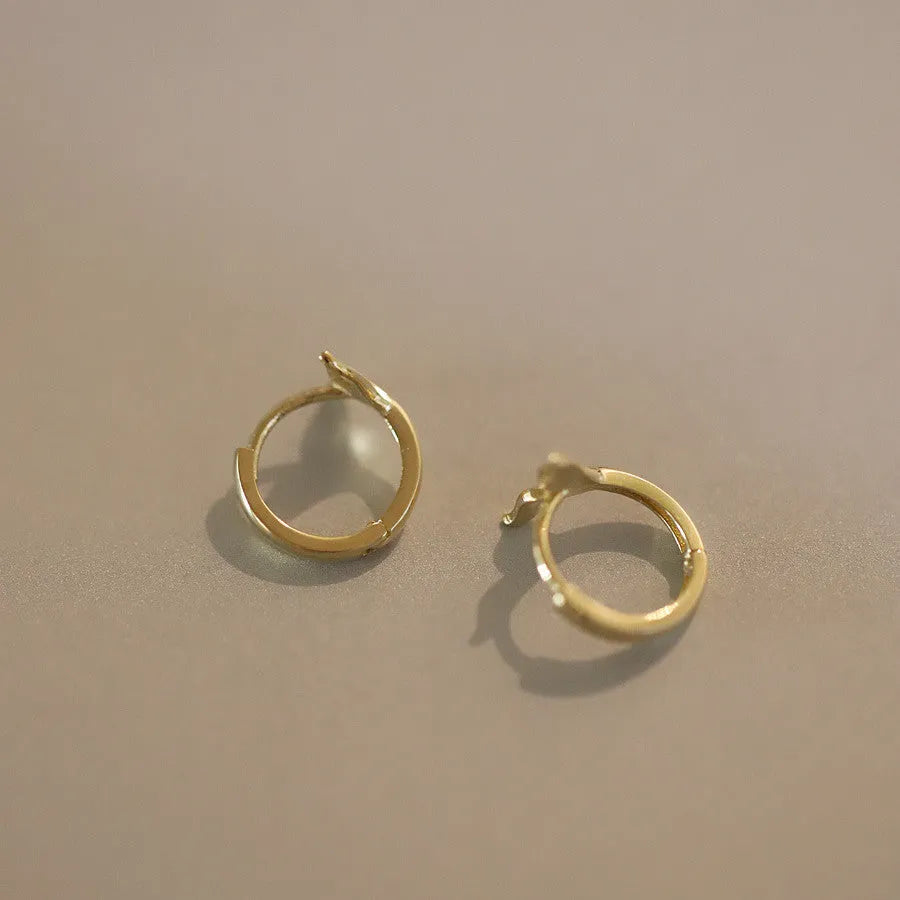 Women's sterling silver fishtail earrings in gold colour with smooth band design