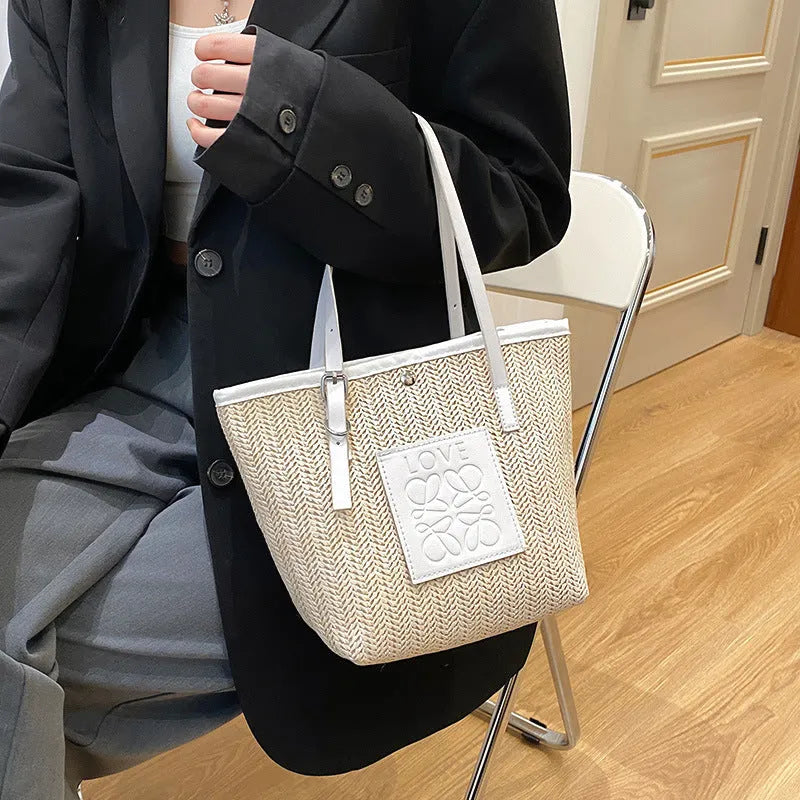 Straw woven women's shoulder bag in black with three-dimensional pockets and 27cm width