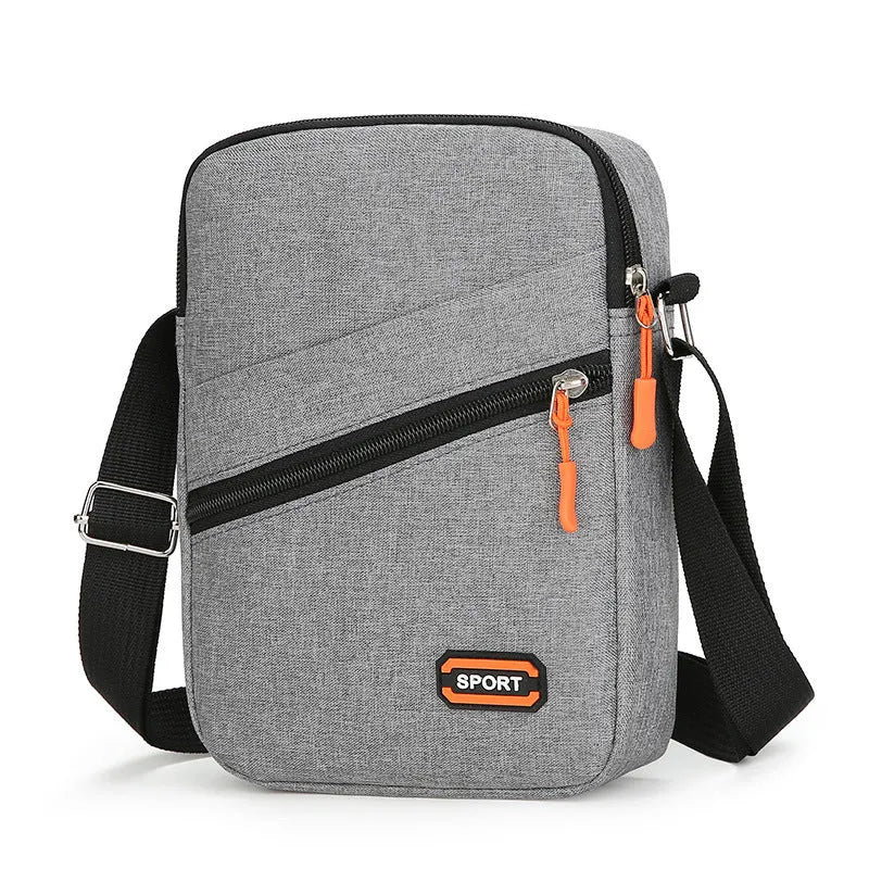 Oxford cloth crossbody commuter bag with contrast detailing in silver grey, black, or navy blue