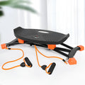 Black foldable mini fitness skiing machine JS101A with elastic hand straps on a home floor.