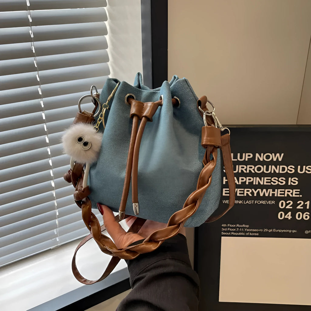 Blue one-shoulder cross body bucket bag with synthetic leather lining and sandwich pockets