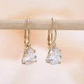 Women's drop-shaped copper earrings with gold finish and decorative platinum inlay.