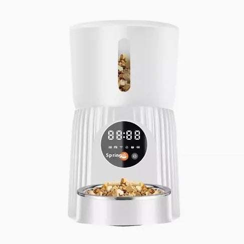 Black and white automatic pet feeder with digital display and food chamber for timed portion control