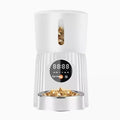 Black and white automatic pet feeder with digital display and food chamber for timed portion control