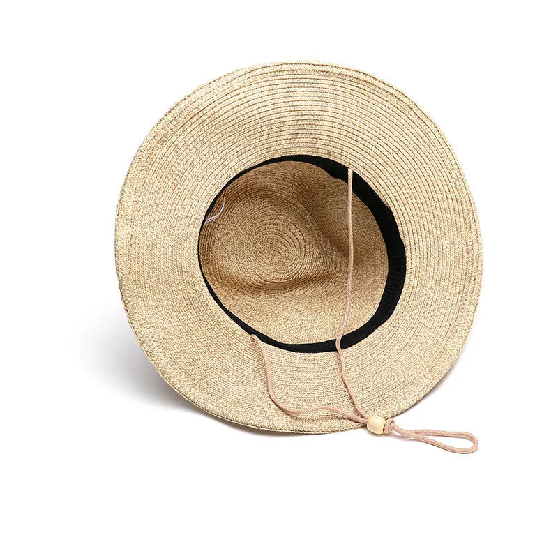 Men's foldable wide-brim straw sun hat in beige on a neutral background