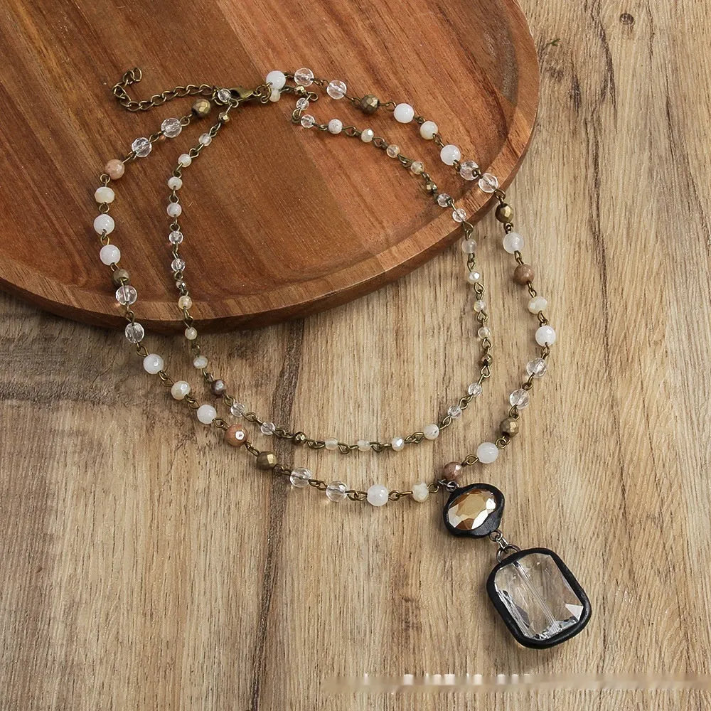 Tribal style two-layer necklace with glass and stone pendants in beige and blue on adjustable chain
