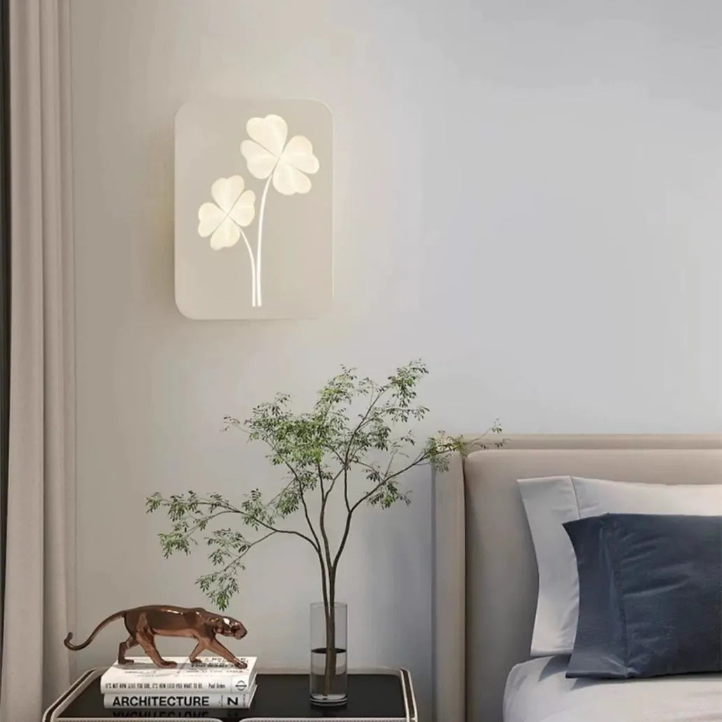 Modern cream coloured bedside lamp with acrylic shade and iron base on a wooden table.