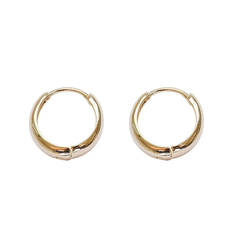 Women's minimalist copper water drop earrings in gold and silver, shown in large, medium, and small sizes.