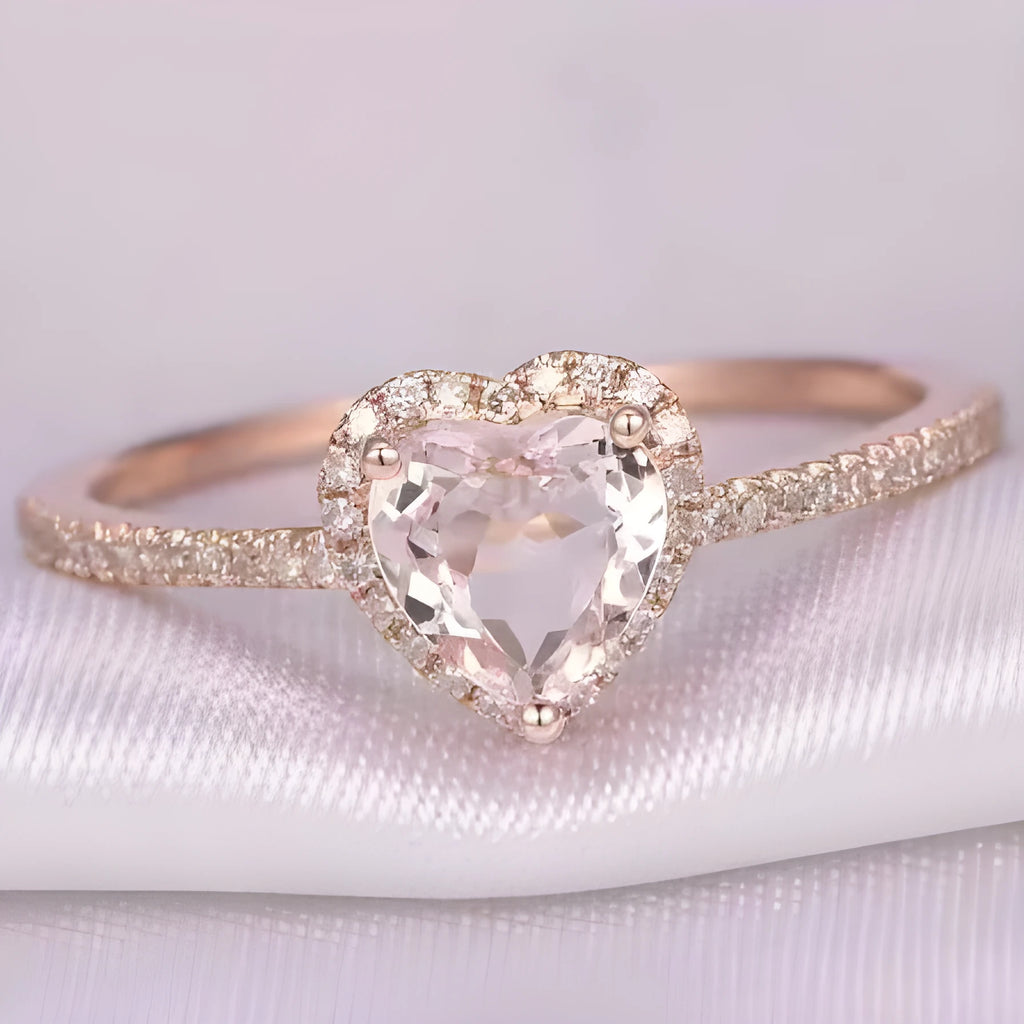 Heart-shaped crystal wedding ring in rose gold or silvery finish on white background