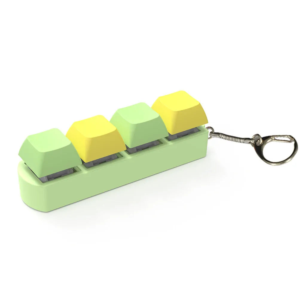 Compact 4-key mechanical keyboard switch tester on a desk, showing coloured ABS plastic construction.