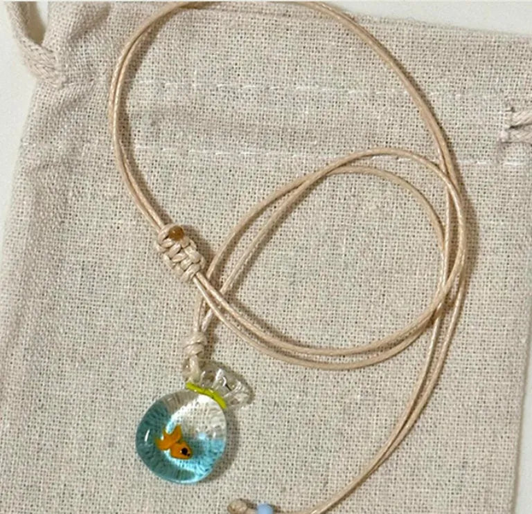 Women's pendant necklace with coloured glaze skirt joker character on a cotton linen clavicle chain.
